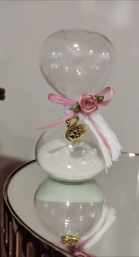 Μπομπονιέρα βάπτισης κλεψύδρα γυάλινη στολισμένη με μεταλλικό κύκνο και σατέν τριανταφυλλάκι